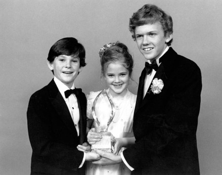 Drew Barrymore, center, Henry Thomas, left, and Robert Macnaughton, the young stars of Steven Spielberg's movie "E.T., The Extra-Terrestrial," pose with their People's Choice award after the movie was named favorite Motion Picture at the 9th annual People's Choice Awards in Santa Monica, Ca., on March 17, 1983. (AP Photo/Lennox McLendon)