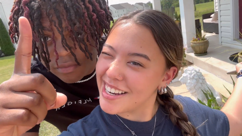 Lennon Johnson holds up one finger while posing beside girlfriend Hannah Gosselin.