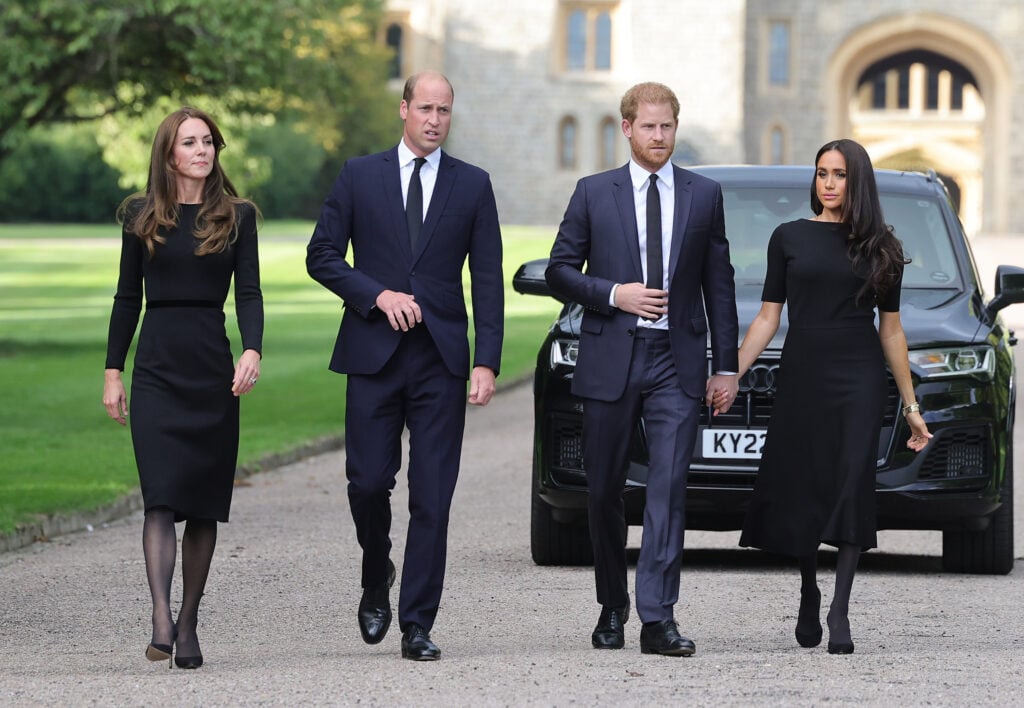 Duchess Kate Middleton, Prince William, Prince Harry, and Duchess Meghan Markle walk together in 2022.