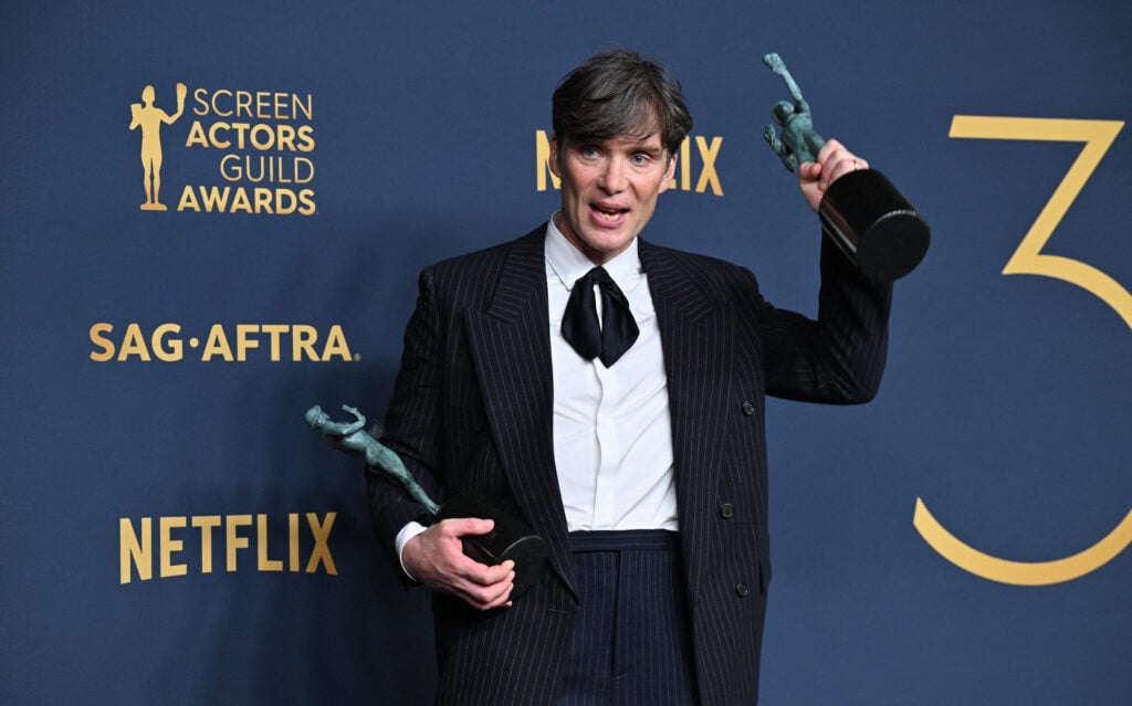 Cillian Murphy poses in the press room with the awards for Outstanding Performance by a Male Actor in a Leading Role in a Motion Picture and Outstanding Performance by a Cast in a Motion Picture for 