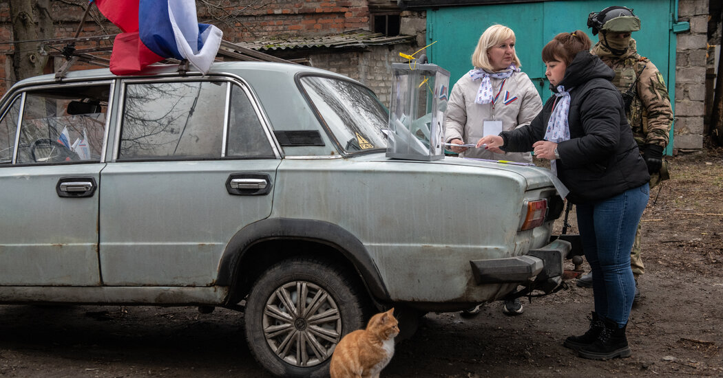 In Occupied Ukraine Casting A Vote For Putin As Armed.jpg