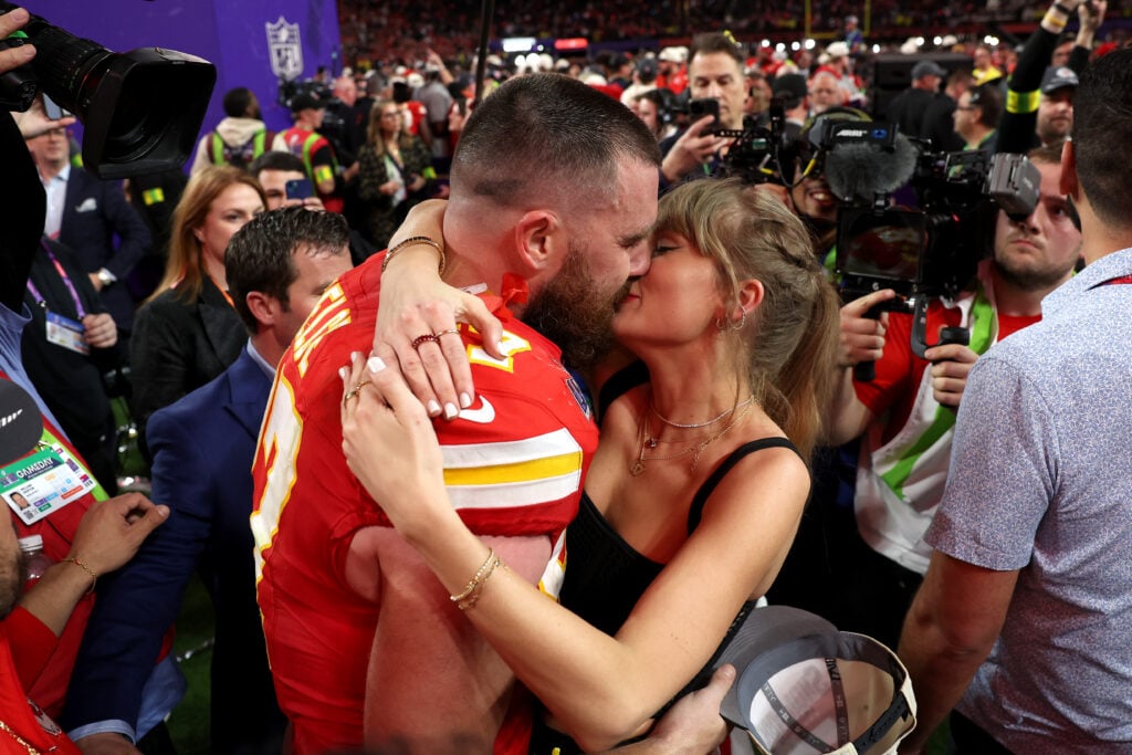 Taylor Swift locks lips with Travis Kelce, kissing after his 2024 Super Bowl victory.