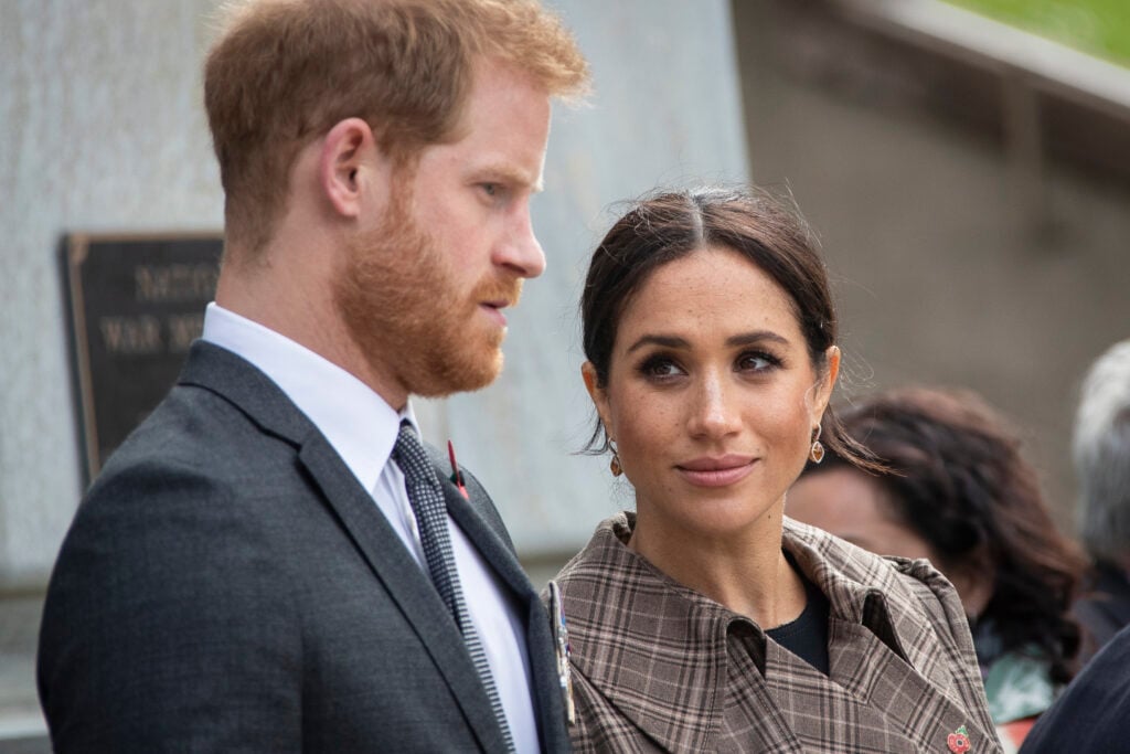 Prince Harry, Duke of Sussex and Meghan, Duchess of Sussex lay ferns and a wreath at the tomb of the Unknown Warrior at the newly unveiled UK war memorial and Pukeahu National War Memorial Park, on October 28, 2018, in Wellington, New Zealand. 